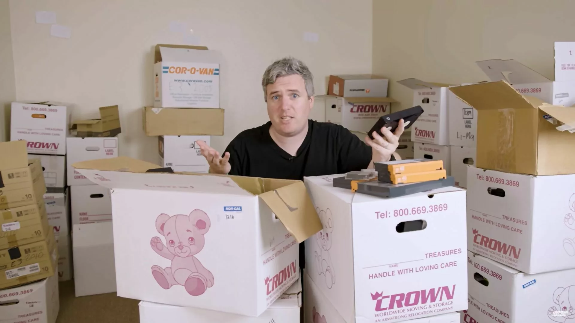 A Noclip video still showing Danny O'Dwyer with boxes of videotapes